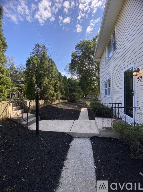 A house numbered 57 with a black and white striped pathway.