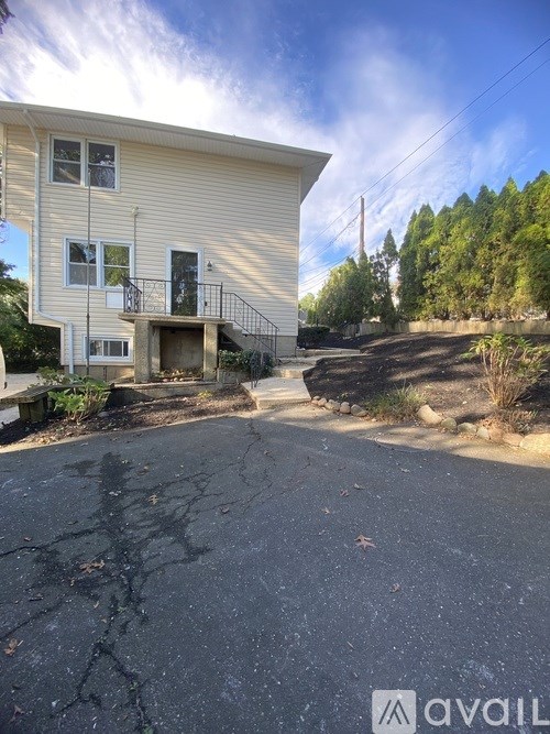 A house with a cracked driveway is for sale.