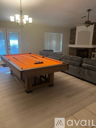 A room with a pool table and a couch.