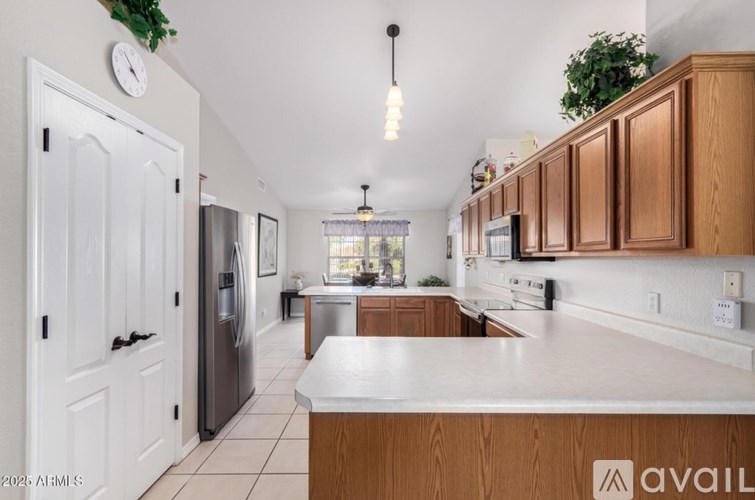 A kitchen with wooden cabinets and a white countertop.