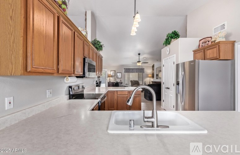 A kitchen with a sink and a refrigerator.