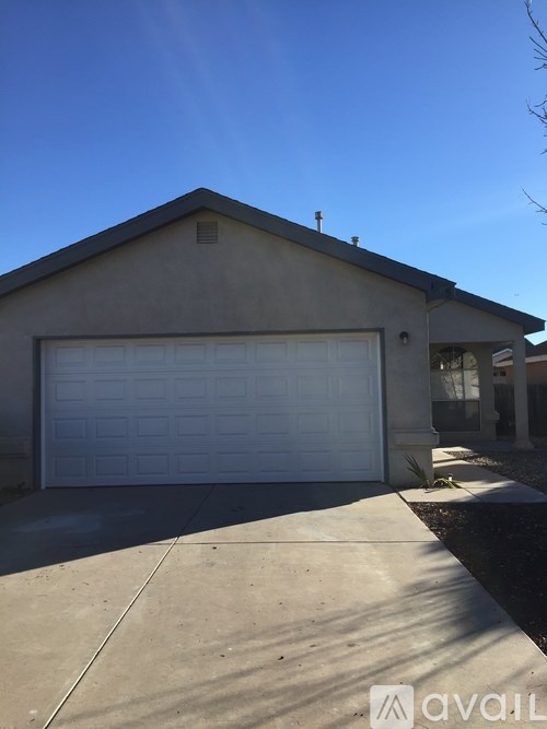 A house with a white garage door and a driveway.