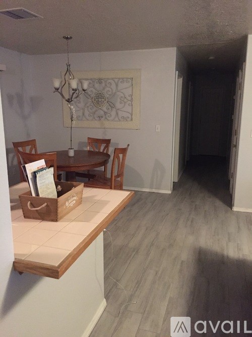 A room with a dining table and chairs.