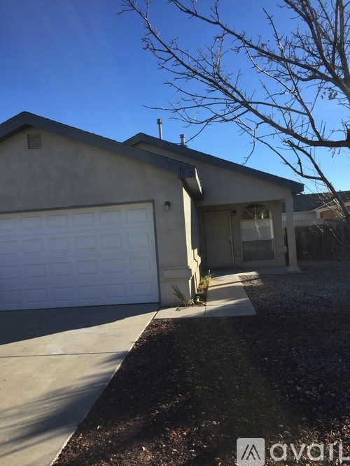 A house with a white garage door and a driveway.