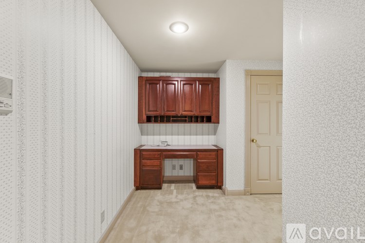 A kitchen with wooden cabinets and a countertop.