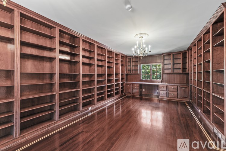 A room with wooden shelves and a chandelier.