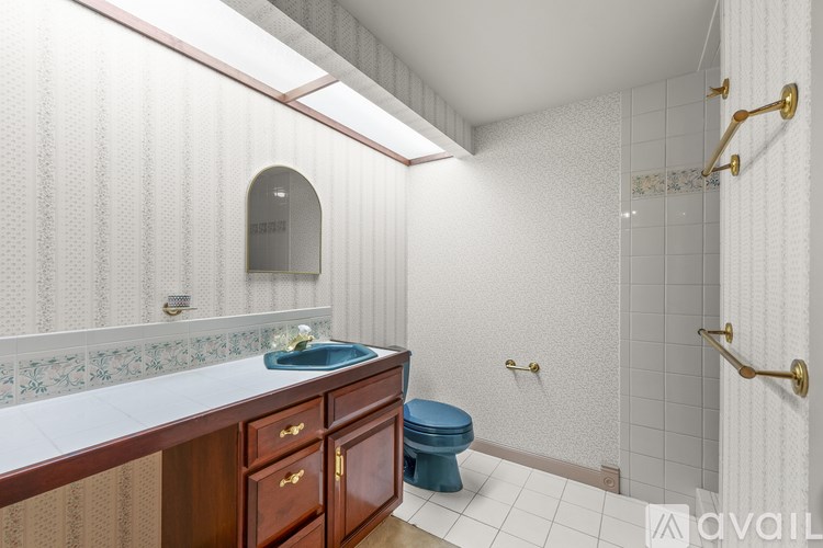 A bathroom with a toilet, sink, and shower.