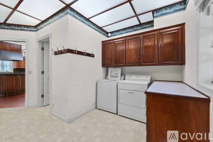 A kitchen with wooden cabinets and a washing machine.