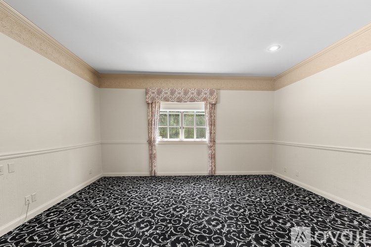 A room with a window and a patterned floor.