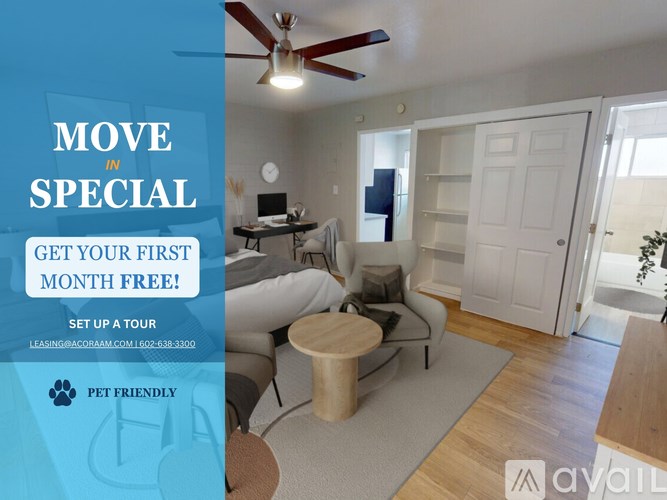 A room with a ceiling fan and a couch with a sign offering a free first month of rent.