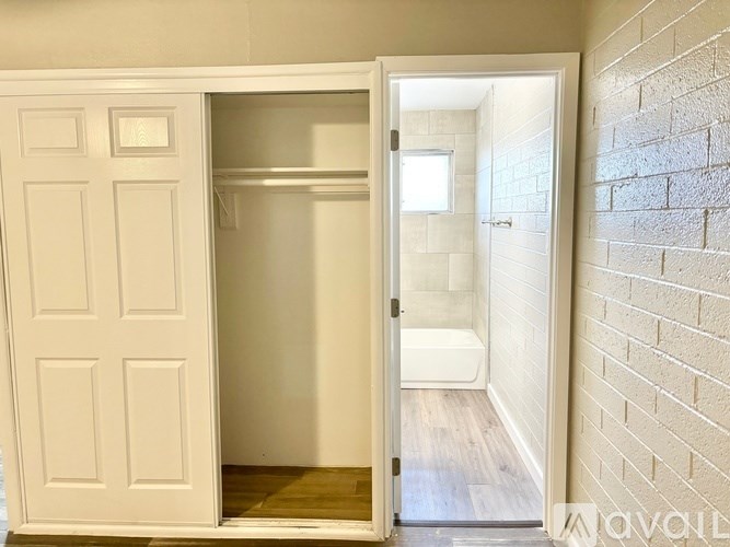A white door is open to a bathroom.