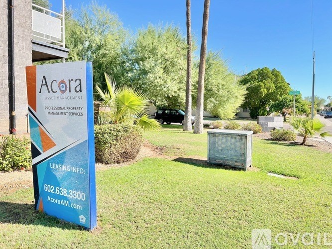 A sign for Acora Asset Management is in front of a building.
