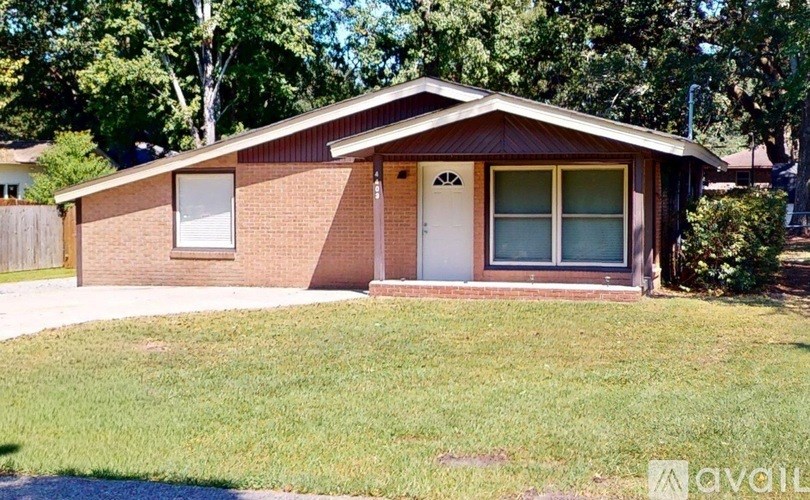 A house with a brown brick exterior and a white door is for sale.