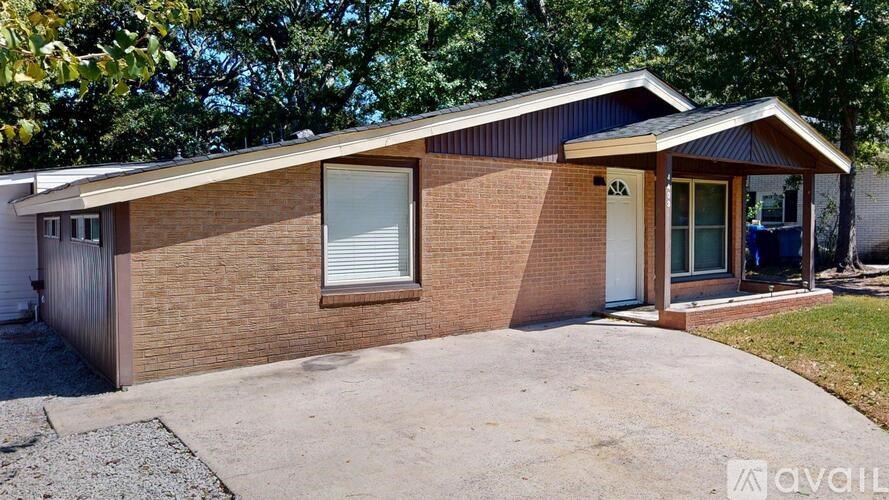 A house with a brick exterior and a white door is for sale.