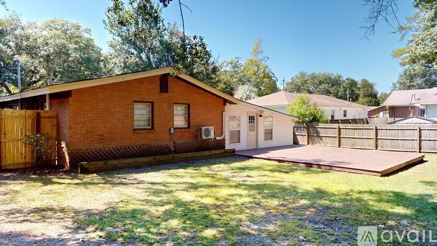A house with a brown brick exterior is for sale.
