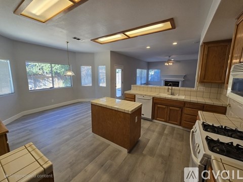 A kitchen with wooden cabinets and a stove top oven.