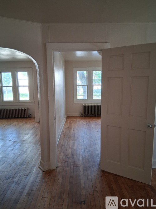 A room with a white door and a window with a white frame.