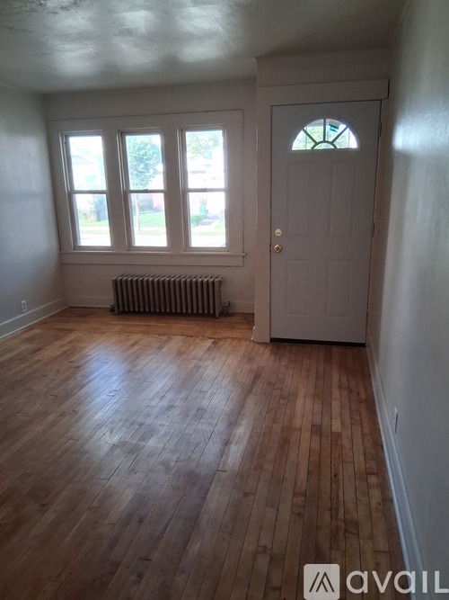 A room with wooden floors and a white door.