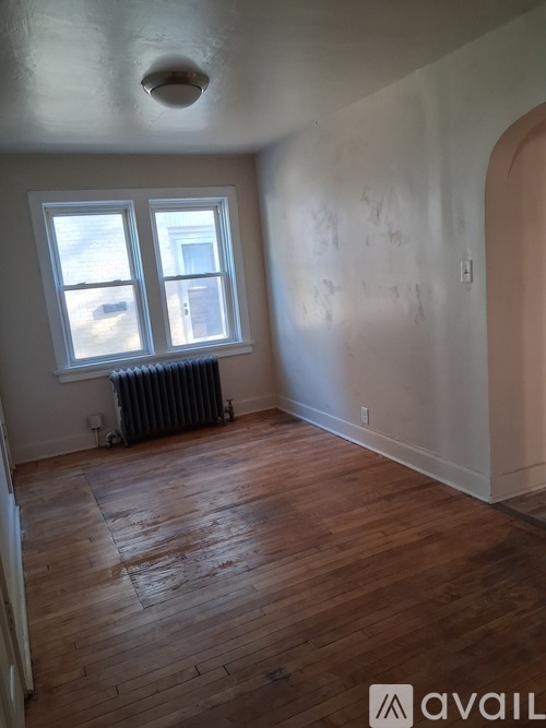 A room with wood flooring and a window.