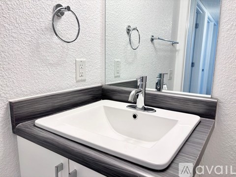 A white sink with a silver faucet is on a counter.
