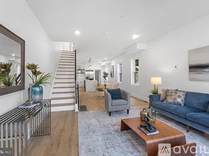 A living room with a staircase and a couch.
