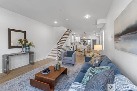 A living room with a blue couch and a wooden coffee table.