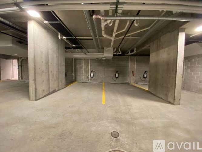 A large, empty parking garage with concrete walls and floors.