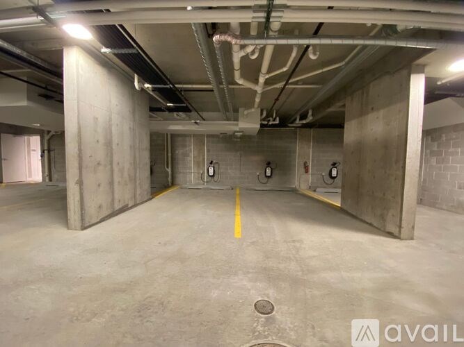 A spacious, empty parking garage with concrete walls and floors.