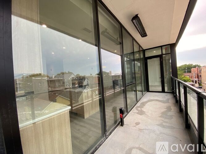 A balcony with glass doors and a red light on the floor.