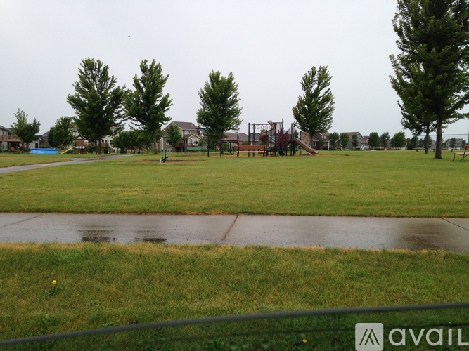 A park with a playground and trees.