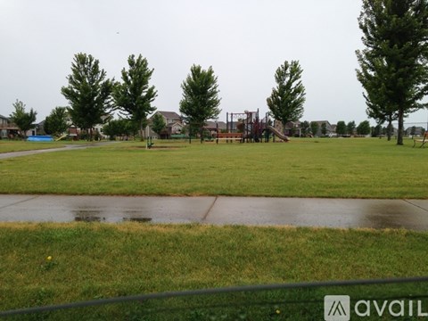 A park with a playground and trees.