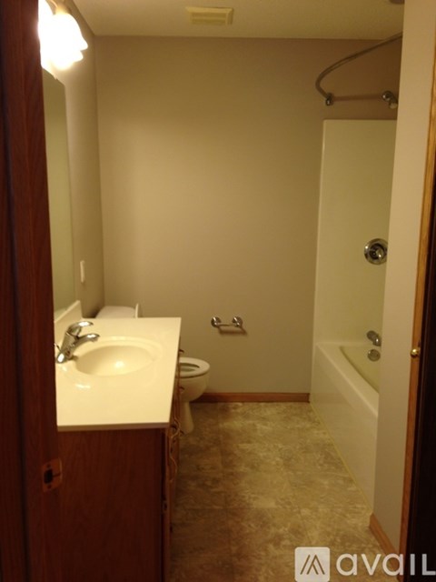 A bathroom with a sink, toilet, and bathtub.
