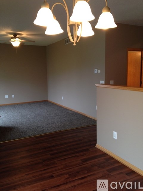 A room with wooden floors and a ceiling fan.