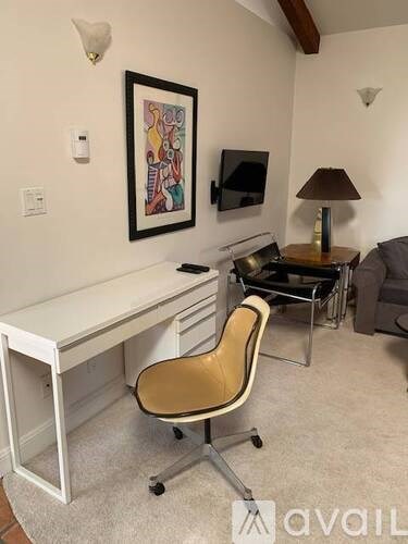 A room with a desk and a chair.