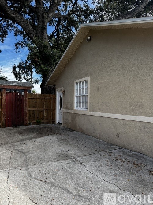 A house with a red door and a window with bars.