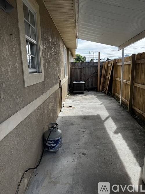 A concrete patio with a gas cylinder on it.