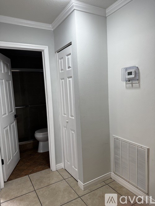 A bathroom with a toilet and a heater.
