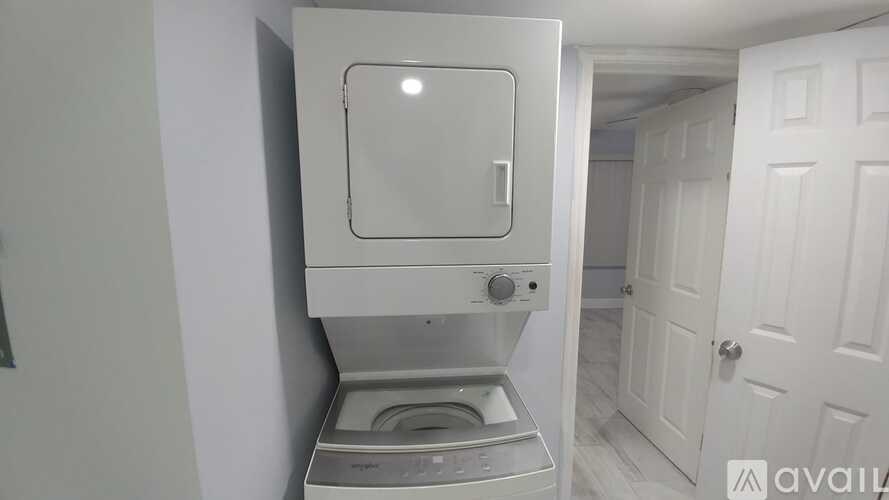 A white washing machine in a small room.