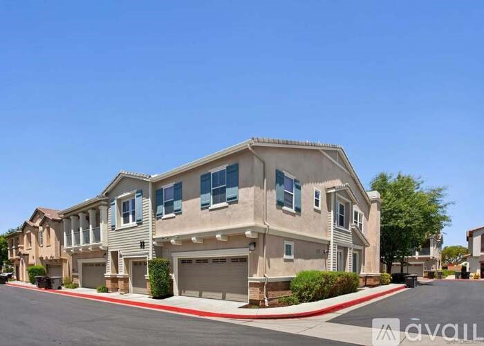 A row of houses with a clear blue sky above them.