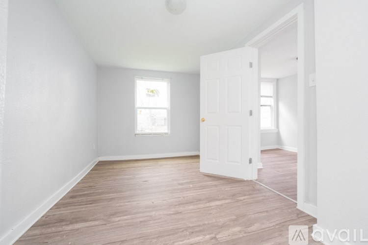 A room with a white door and a window.