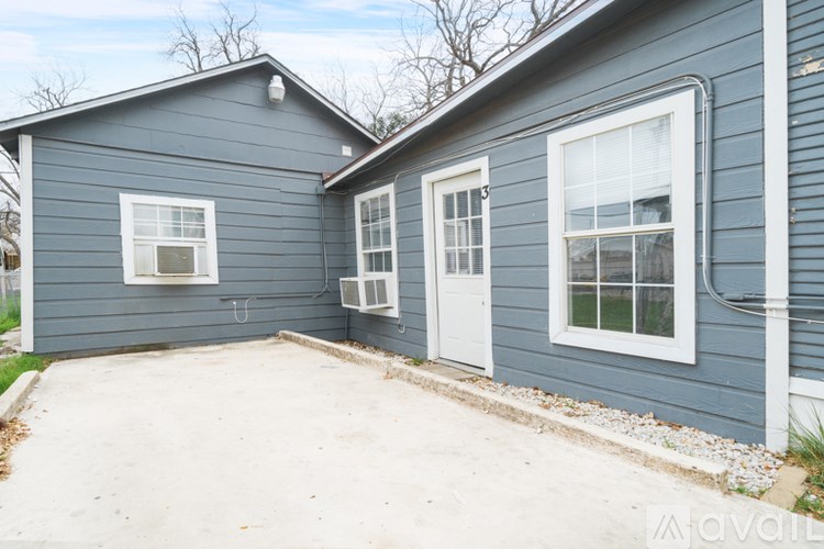 A blue house with a white door and windows.