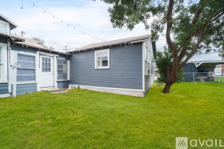 A house with a blue and grey exterior is available for rent.