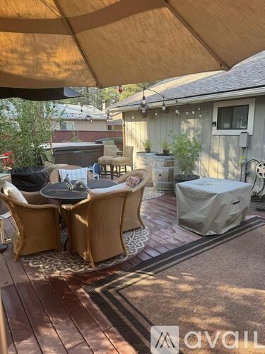 A patio with a table and chairs under a canopy.