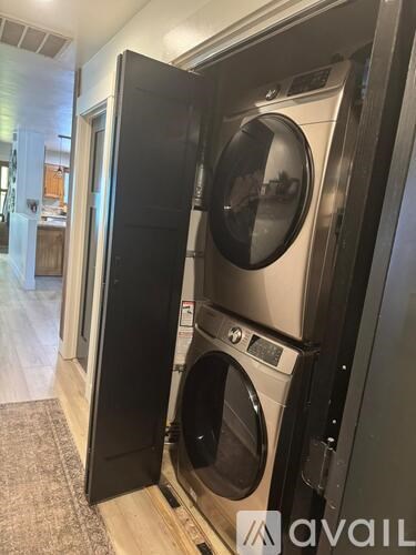 A washer and dryer combo unit is installed in a wall.