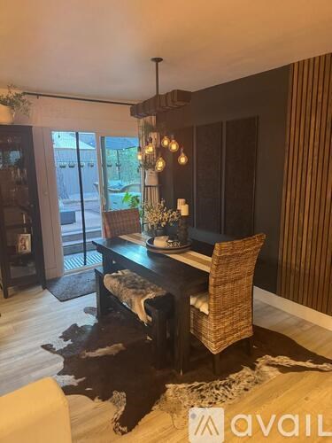 A dining room with a wooden table and chairs.