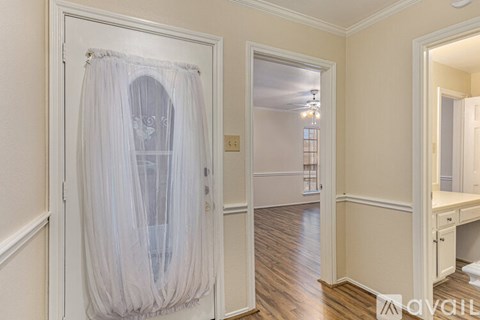 A room with a white canopy bed in the middle.
