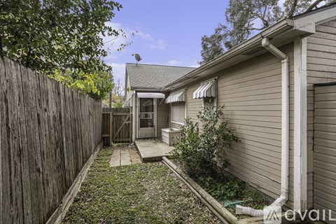 A backyard with a wooden fence and a small garden area.
