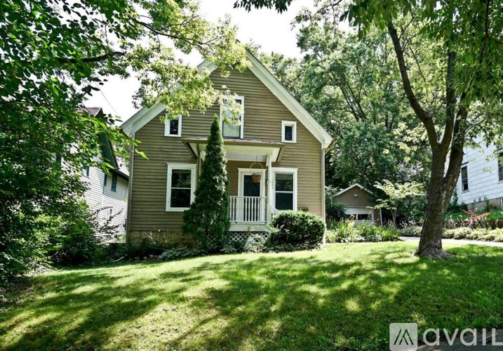 A house with a tree in front of it.