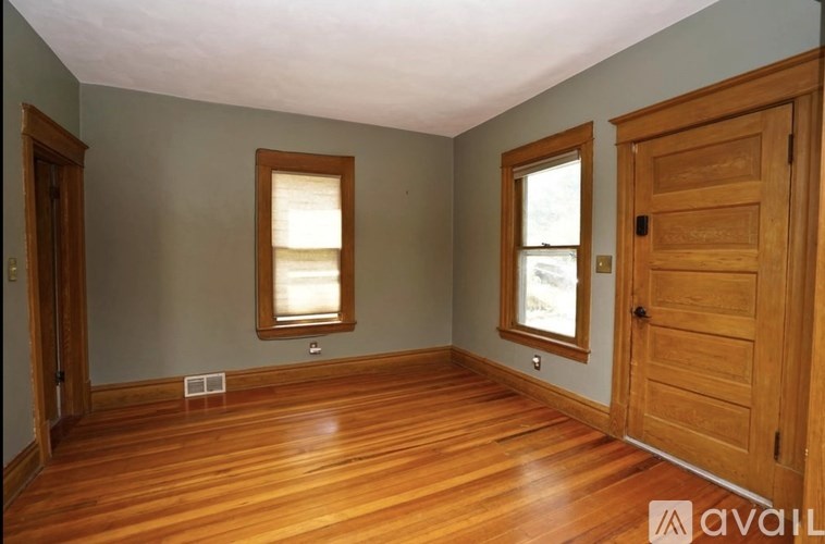 A room with wooden floors and a wooden door.