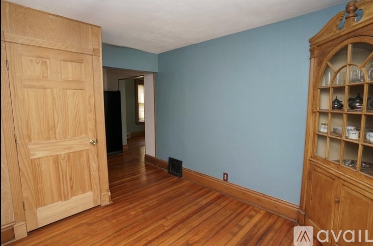 A room with a wooden floor and a wooden door.
